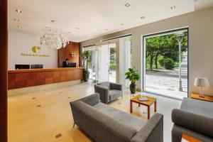 a living room with a couch and a chair at Hotel dei Cavalieri Caserta - La Reggia in Caserta