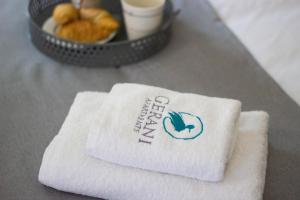 a pile of towels sitting on top of a table at Potamos Studios by GERANI in Órmos