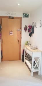 a room with a door and a table and a desk at Modern Apartment in Calafell + Terrace in Calafell
