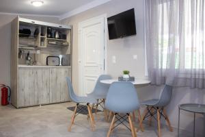a kitchen and dining room with a table and chairs at Potamos Studios by GERANI in Órmos