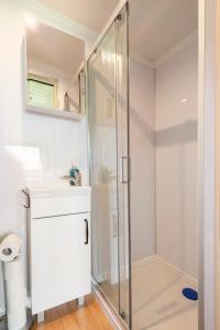 a bathroom with a shower and a sink at Offgrid Tiny Home W/ Spectacular View Of Cotswolds in Cheltenham