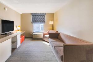 a living room with a couch and a television at Hampton Inn Fall River/Westport in North Westport