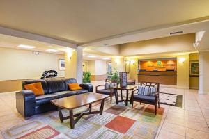 a lobby with a couch and chairs and a table at Quality Inn & Suites NRG Park - Medical Center in Houston