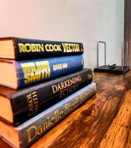 a stack of books sitting on top of a table at No Loadshedding Fast WiFi Lux Apartment in Johannesburg +17 photos