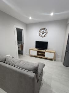 a living room with a couch and a flat screen tv at Brisas marinas in Malpica