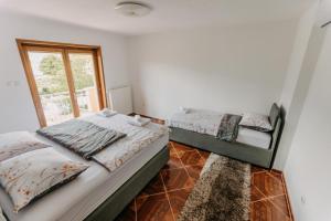 two beds in a room with a window at Villa Lamija in Bihać +44 photos