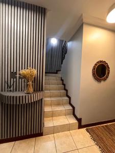 a hallway with a staircase with a vase of flowers at Bluestream Villas in Pretoria