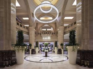 a lobby with a large building with a chandelier at Makkah Clock Royal Tower, A Fairmont Hotel in Makkah