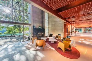 a lobby with tables and chairs and large windows at Almenat Embu Das Artes Sao Paulo, Tapestry Collection in Embu +37 photos