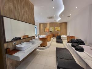 a large bathroom with sinks and a row of mirrors at Ivory Villas & Resort - Villa view hồ Lake View in Rống Vong