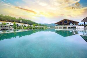 a view of the water at a resort at Ivory Villas & Resort - Villa view hồ Lake View in Rống Vong
