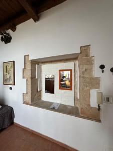 Cette chambre est dotée d'un mur en pierre et d'une fenêtre. dans l'établissement Terrace on the sea, à Syracuse