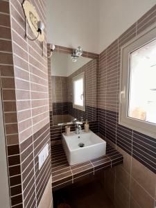 a bathroom with a sink and a mirror at BISCOTTAI Port Apartments in Trapani