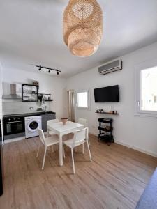 a living room with a white table and chairs at BISCOTTAI Port Apartments in Trapani +14 photos