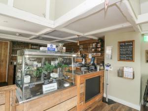 a restaurant with a counter with a display case at Harcombe House Bungalow 1 in Newton Abbot