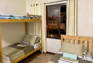 a bedroom with two bunk beds and a window at Emma's Comfy Space in Manila +15 photos