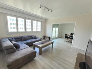 a living room with a couch and a table at Appartement T5 avec 3 chambres in Brest