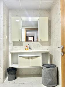 une salle de bains avec un lavabo et un miroir dans l'établissement Prodige meublées, à Abidjan 13 autres photos