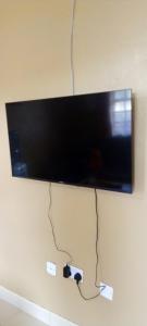 a flat screen tv hanging on a wall at Best Homestay in Naivasha +3 photos