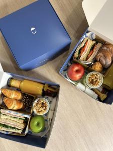 due scatole riempite con diversi tipi di alimenti accanto a un portatile di MDD4 Health Experience Hotel - Adults Only a Siviglia