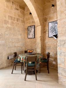 a dining room with a table and chairs at Terrace Room on Parish Street in Luqa