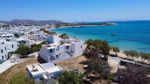an aerial view of a beach with white buildings and the ocean at House on the beach Agia Anna Naxos in Agia Anna Naxos