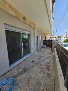 a balcony of a house with a large window at Cute Corner in Khalkoútsion