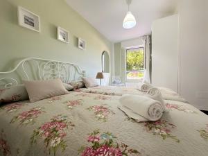 a bedroom with two beds with pillows on them at Apartamentos Playa La Arena Encinar in Isla +94 photos