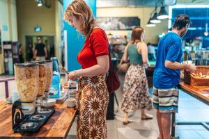 a woman standing at a counter in a store at Abraham Tel Aviv in Tel Aviv