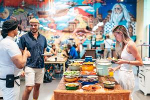 a group of people standing around a table with food at Abraham Tel Aviv in Tel Aviv