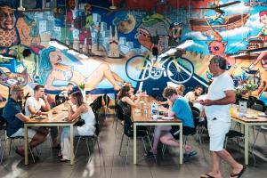 a group of people sitting at tables in a restaurant at Abraham Tel Aviv in Tel Aviv