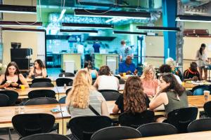 a group of people sitting at tables in a room at Abraham Tel Aviv in Tel Aviv