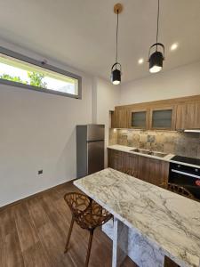 a kitchen with a large marble table and chairs at Cute Corner in Khalkoútsion +14 photos