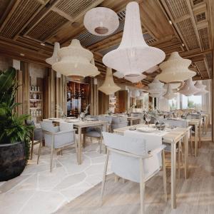 un restaurant avec des tables, des chaises et des lustres blancs dans l'établissement LIOQA Resort, à Ugljan