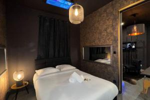 a bedroom with a large white bed and a mirror at love Room claire 1 - climatisation in Lyon