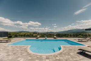 a swimming pool with a view of the mountains at Villa Lamija in Bihać