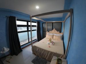 Postel nebo postele na pokoji v ubytování La Salangane Beach Hotel - Downtown