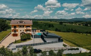 an aerial view of a house with a swimming pool at Villa Lamija in Bihać