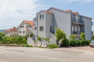 a row of houses on the side of a street at Centrally located apartments, free parking in Trogir