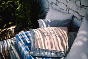 a pile of towels sitting on top of a couch at Sea Side Studios & Houses in Kalo Livadi
