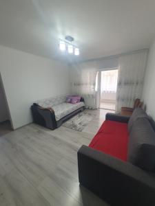 a living room with a bed and a couch at Apartament Beatrice in Năvodari