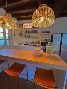 a kitchen with two lights and a counter with chairs at Casa vacanze ViaColoniola37 in Como