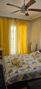 a bedroom with a bed with yellow curtains and a ceiling at Perea Silvi suite in Perea