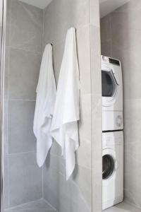 a bathroom with a washing machine and white towels at Casa na Aldeia in Arcos de Valdevez +14 photos