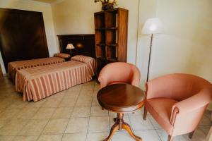 Postel nebo postele na pokoji v ubytování Hotel Hacienda Don Manuel