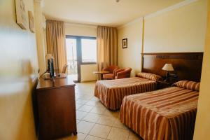 Postel nebo postele na pokoji v ubytování Hotel Hacienda Don Manuel