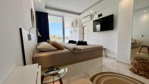 a small bedroom with a bed and a window at Tenerife Sea View Sun Beach Apartment 220 in Playa Fañabe