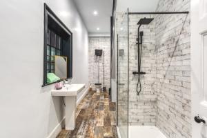 a bathroom with a sink and a shower at Friar Gate House - Grand Georgian Townhouse in Derby Centre in Derby