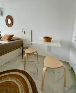 a living room with two stools and a bed at Tenerife Sea View Sun Beach Apartment 220 in Playa Fañabe