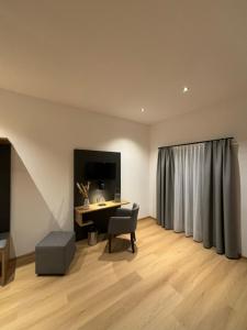 a room with a desk and a chair and a curtain at Hotel Restaurant Hafenwirt in Seeon-Seebruck